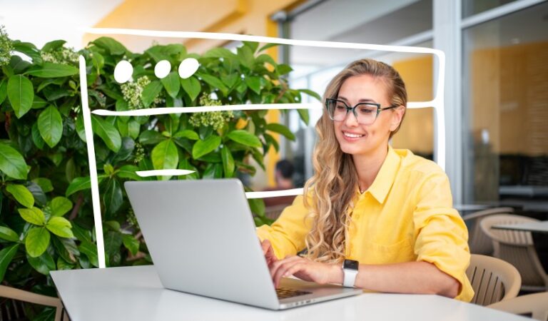 woman working on laptop in a bright cafe for substack blogging and online writing