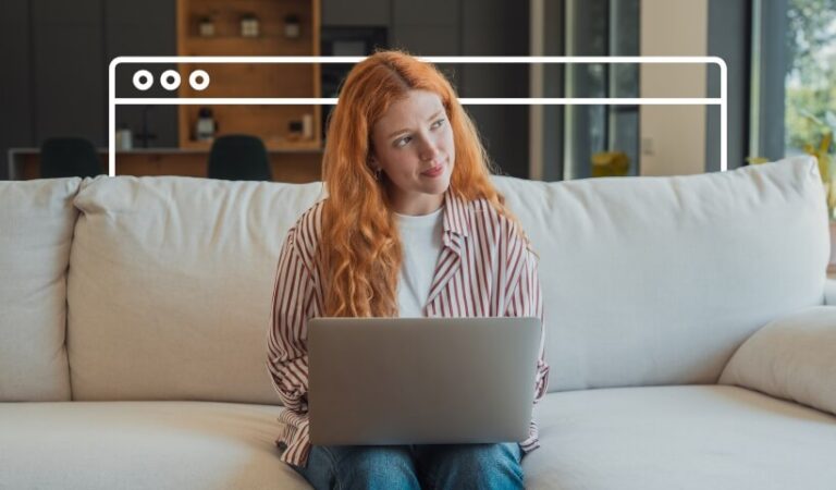 Woman sitting on a couch with a laptop deciding between Shopify and Etsy