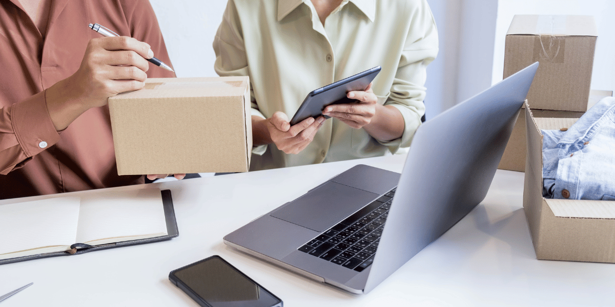 Small business owner checking product packaging and tracking orders on tablet